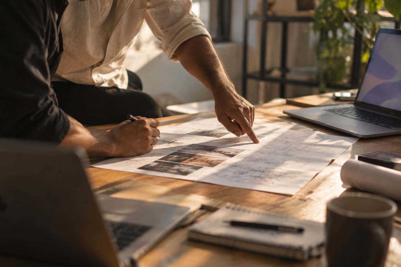 Two people reading a printed page together, one pointing to a line.