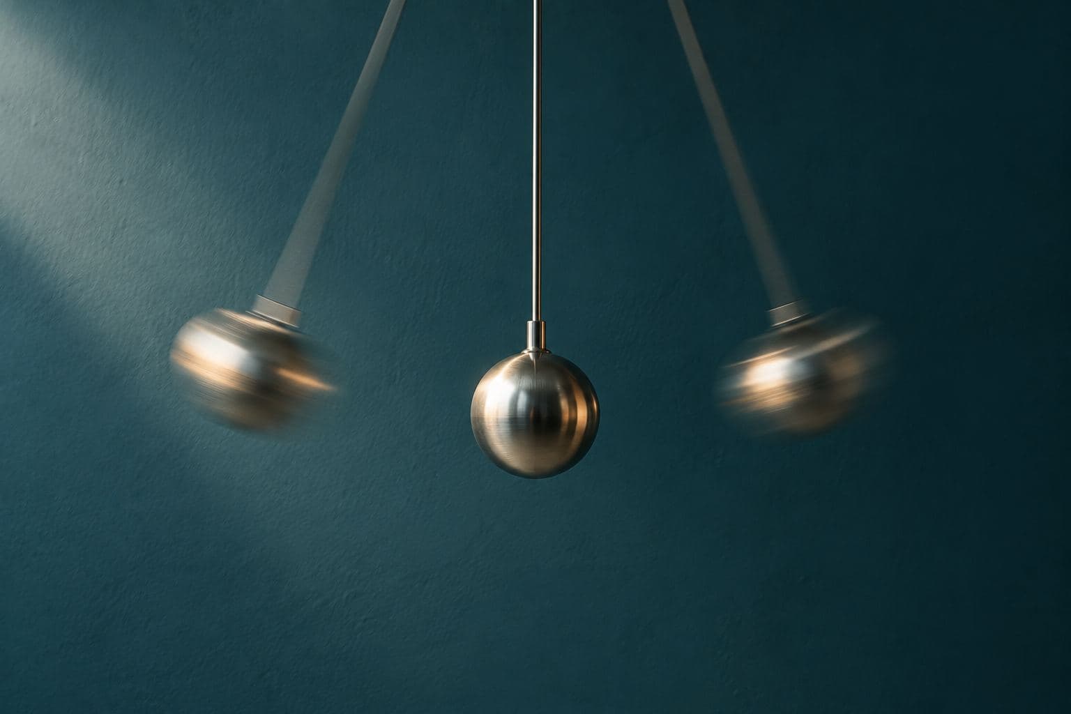 A steel pendulum caught mid-swing.